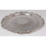 A late Victorian silver salver, having a pierced and flower head embossed raised edge,