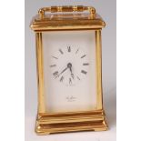 A St James' of London lacquered brass carriage clock, having a signed white enamel dial,