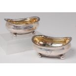 A pair of George III boat shaped table salts, each having egg and dart rims, gilt washed bowls,
