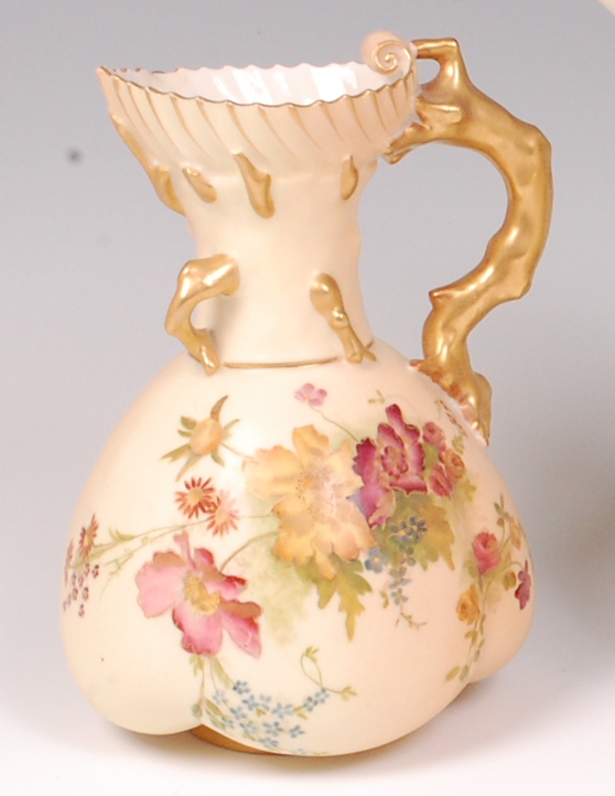 A Royal Worcester blushware jug, decorated with sprays of wildflowers and heightened in gilt,