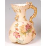 A Royal Worcester blushware jug, decorated with sprays of wildflowers and heightened in gilt,