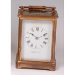 A late 19th century lacquered brass carriage clock, the white enamel dial signed Charles Shapland,