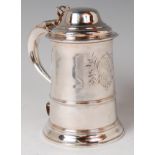 An early George III silver lidded tankard, the hinged domed cover with pierced thumb-piece,