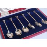 A cased set of six silver gilt teaspoons, each having fox mask terminals,