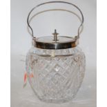 An early 20th century cut glass biscuit barrel with silver plated mounts