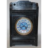 An Aesthetic Movement mantel clock, having an ebonised case,