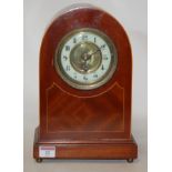 An Edwardian mahogany and satinwood strung mantel clock, having an enamel dial with Arabic numerals,