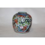 A Chinese export stoneware jar, enamel decorated with dragons and flowers,