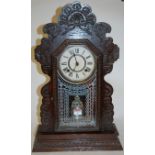 A late 19th century continental oak cased mantel clock,