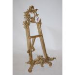 A reproduction gilt brass table easel in the Rococo style