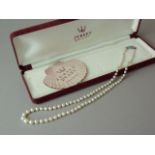 A single strand necklace of graded freshwater pearls, with a silver marcasite box clasp, in a