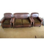 A 1930s brown hide upholstered three piece suite