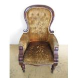 A Victorian button-upholstered mahogany armchair