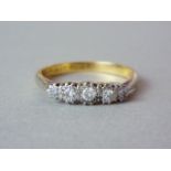 An early 20th Century five stone diamond ring, the illusion set brilliants crown mounted in platinum