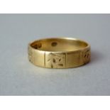 A 19th Century 18ct gold wedding band, the face engraved with foliate cells