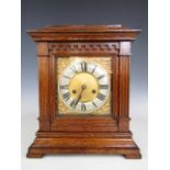 A late 19th Century oak cased architectural mantle clock, with two train movement, brass dial,