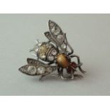 A Victorian novelty silver and tiger's eye brooch in the form of a bee, the insect's thorax claw-set