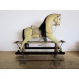 A Victorian rocking horse in the manner of Ayres, in dapple grey with glass eyes and real hair