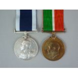 A 1914 Mercantile Marine Medal to John P Roberts together with a George V Navy Long Service and Good