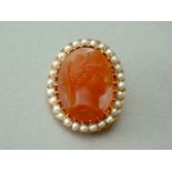 A pearl and sardonyx cameo brooch, carved with the profile portrait of a Greek goddess, crown set