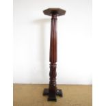 A late 19th / early 20th Century carved mahogany torchere, 134 cm