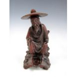 A Chinese carved figure of a sage holding a Ruyi, 15 cm high