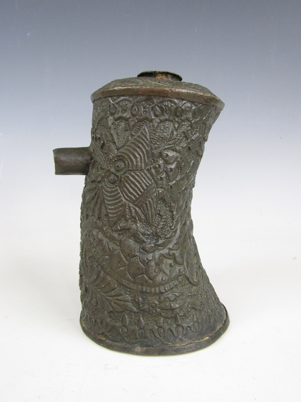 An antique Chinese or Asian copper flask, chased overall in a pattern of sea monsters or dragons,