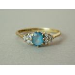 A diamond and aquamarine dress ring, with central oval faceted stone of approximately 0.33ct,