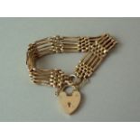 A 9ct gold gate-link bracelet with padlock clasp, 12.3g