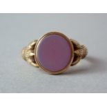 A Victorian gentleman's hardstone signet ring, the plain matrix being held by a pair of clawed paws,