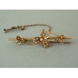 A late Victorian 15ct gold and split seed pearl bar brooch, the face surmounted by pearl set foliage