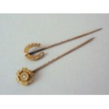 A late 19th Century 15ct gold stick pin, the terminal modelled in the form of a flowerhead,