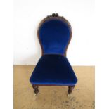 A Victorian upholstered and carved mahogany spoon-back boudoir chair