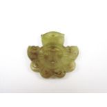 A Chinese jade ornament, carved in depiction of an annulus entwined by stylized serpents and