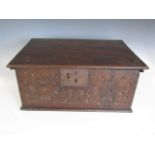 An 18th Century oak bible box, the front face carved in a bass relief pattern of quatrefoils and