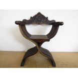 A 19th Century Venetian style carved walnut X-frame armchair