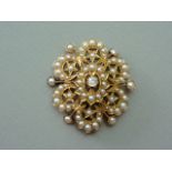 A late Victorian Belle Epoch diamond and pearl pendant brooch, in an openwork arrangement with