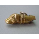 A Victorian yellow metal novelty fob whistle modelled as the head of a dog, 45 cm