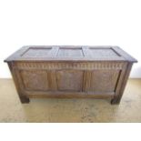 A fine 17th Century joined-oak bedding chest, of three-panel construction, each panel carved in bass