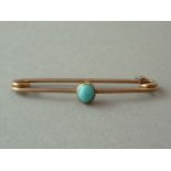 A 1920s turquoise stock pin, the cabochon stone of approximately 5mm, centrally rub set and