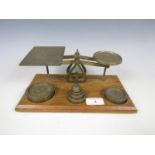 A set of brass postal scales with weights