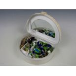 An embroidered jewellery box containing a contemporary dichroic glass pendant and sundry costume