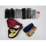 Six lighters together with a cased cheroot holder and a cased pipe (a/f)