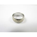 An 18ct white gold wedding band, faceted in a diaper design, 6.3g