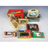 A quantity of boxed die cast cars including a Britains tractor