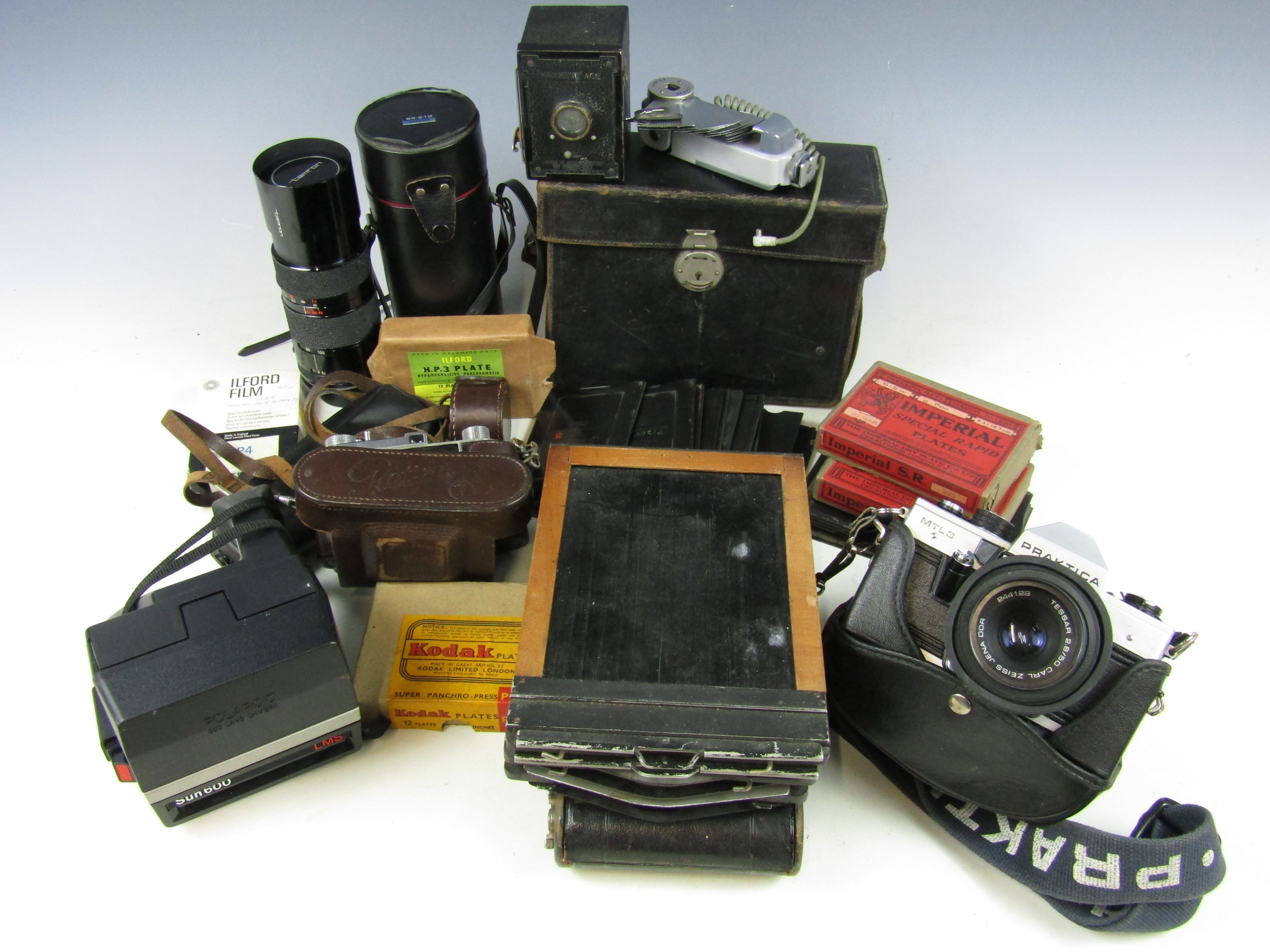 A quantity of cameras including a Praktica MTL3, Lens Tamrun 85 - 210mm zoom, Hawkeye Ace, folding