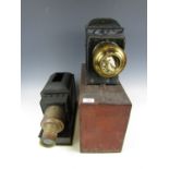 An antique magic lantern with brass lens (a/f) together with one other