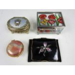 A vintage Stratton pressed powder compact, with enamelled and marcasite-set iris blossom mounted
