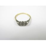 An 18ct gold, platinum and diamond dress ring, cathedral and illusion-set with three stones, the