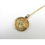 A yellow-metal St Christopher pendant with neck chain